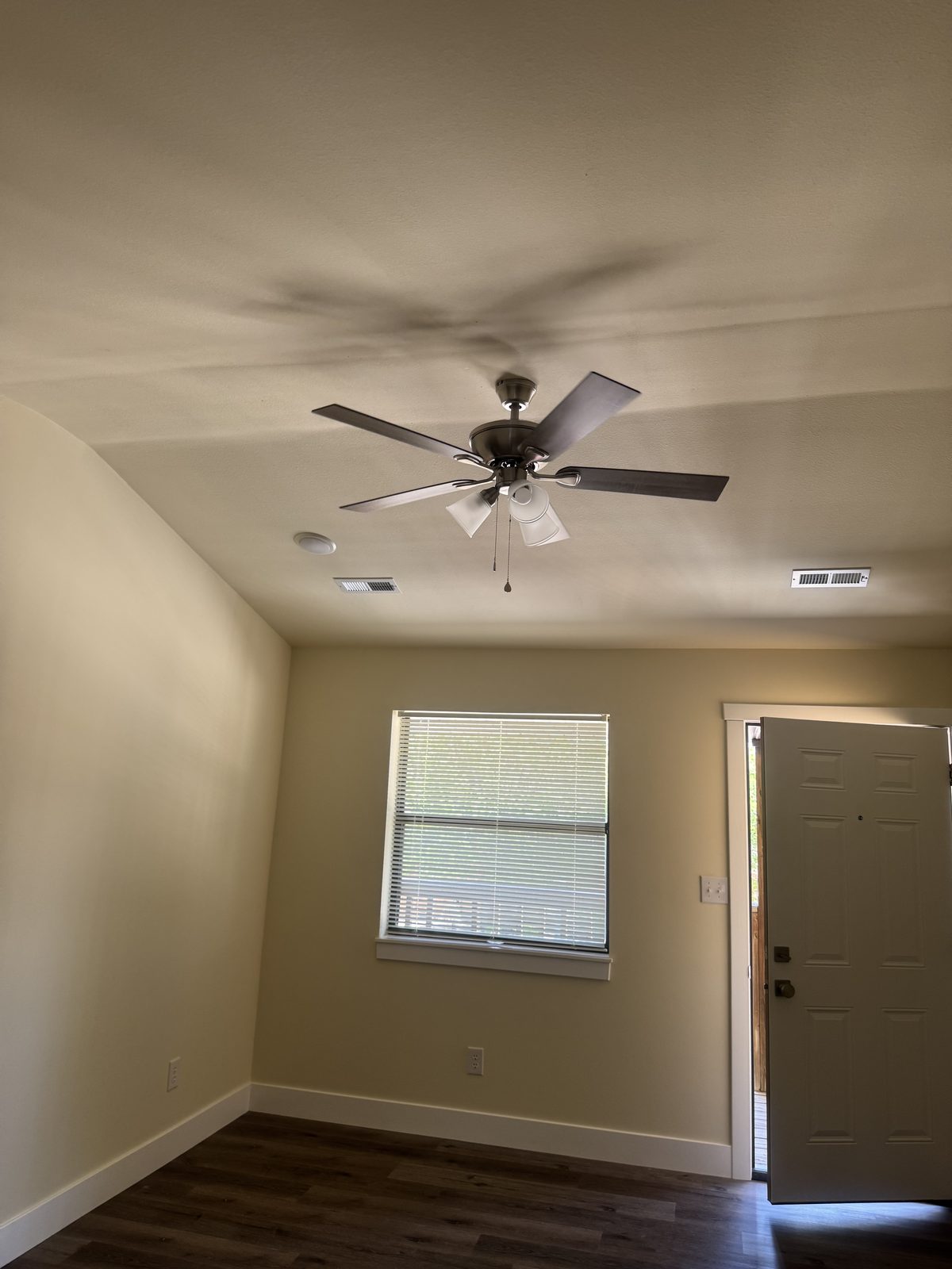 Living room with ceiling fan, natural light, and luxury vinyl plank flooring